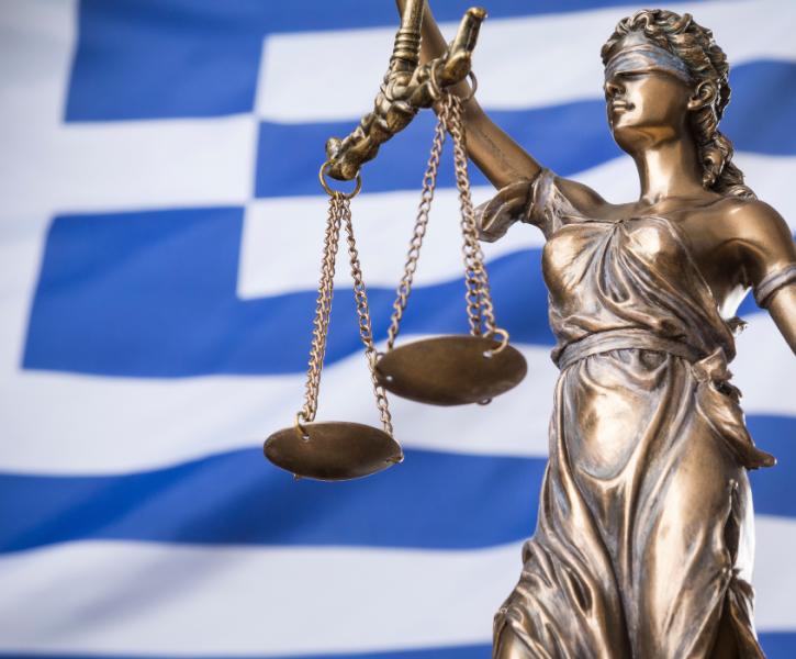Η Θέμιδα μπροστά στην ελληνική σημαία Άγαλμα Θέμιδος Ελλάδα